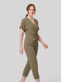Lyra draped knot jumpsuit in olive green, wrap V-neck with knotted waist, on model